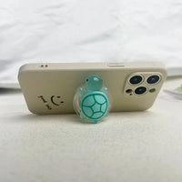 Luminous Plastic Turtle Phone Holder With Expanding Stand And Finger Grip